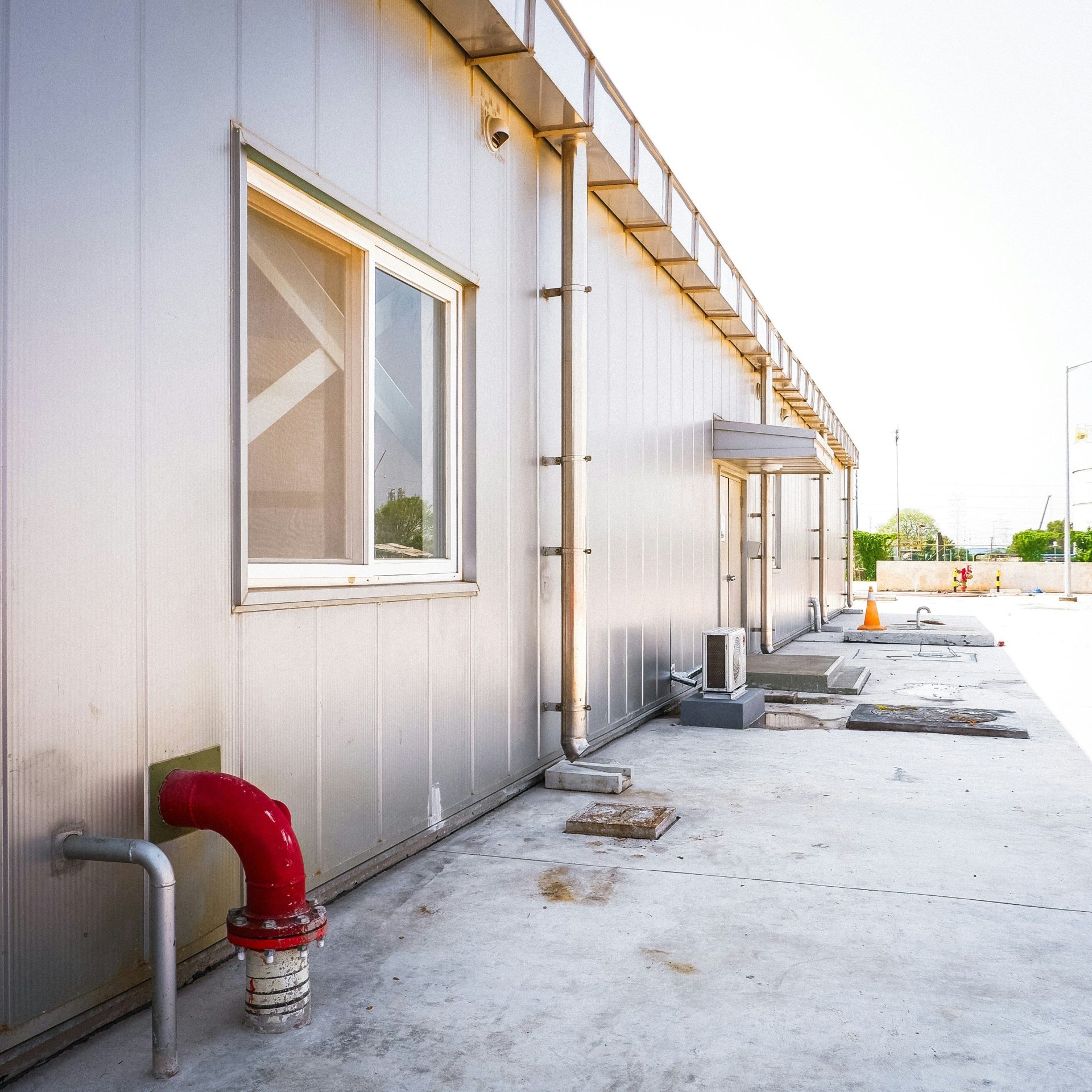 A red fire hydrant sitting next to a building