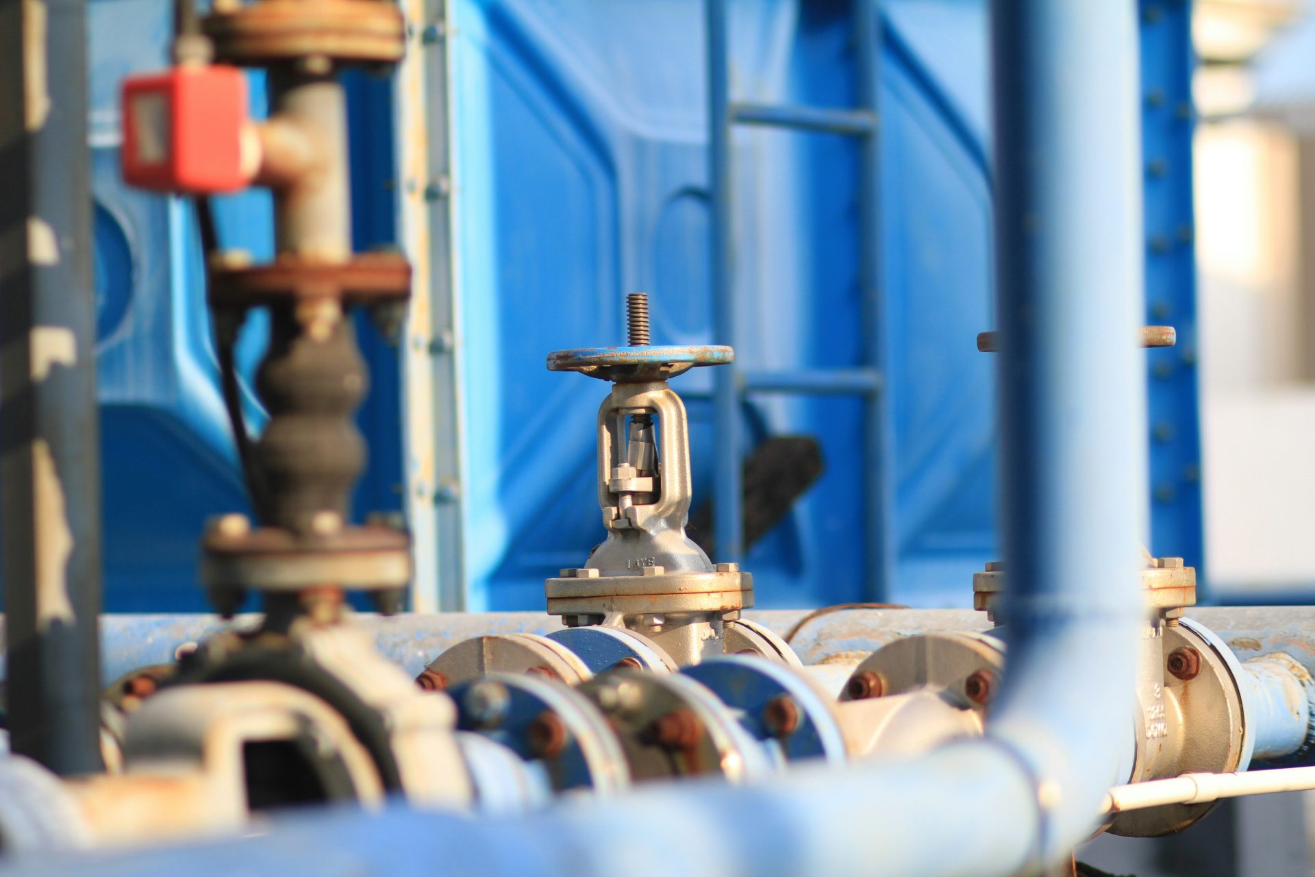 a close up of pipes and valves in a factory